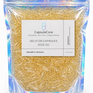 May include: A clear, iridescent pouch filled with numerous Size 00 gelatin capsules. The label reads "CapsuleCore" and lists "Food Grade - Easy to Fill - Strong Capsules." The bag contains 1000 empty capsules, with ingredients listed as beef gelatin and purified water.