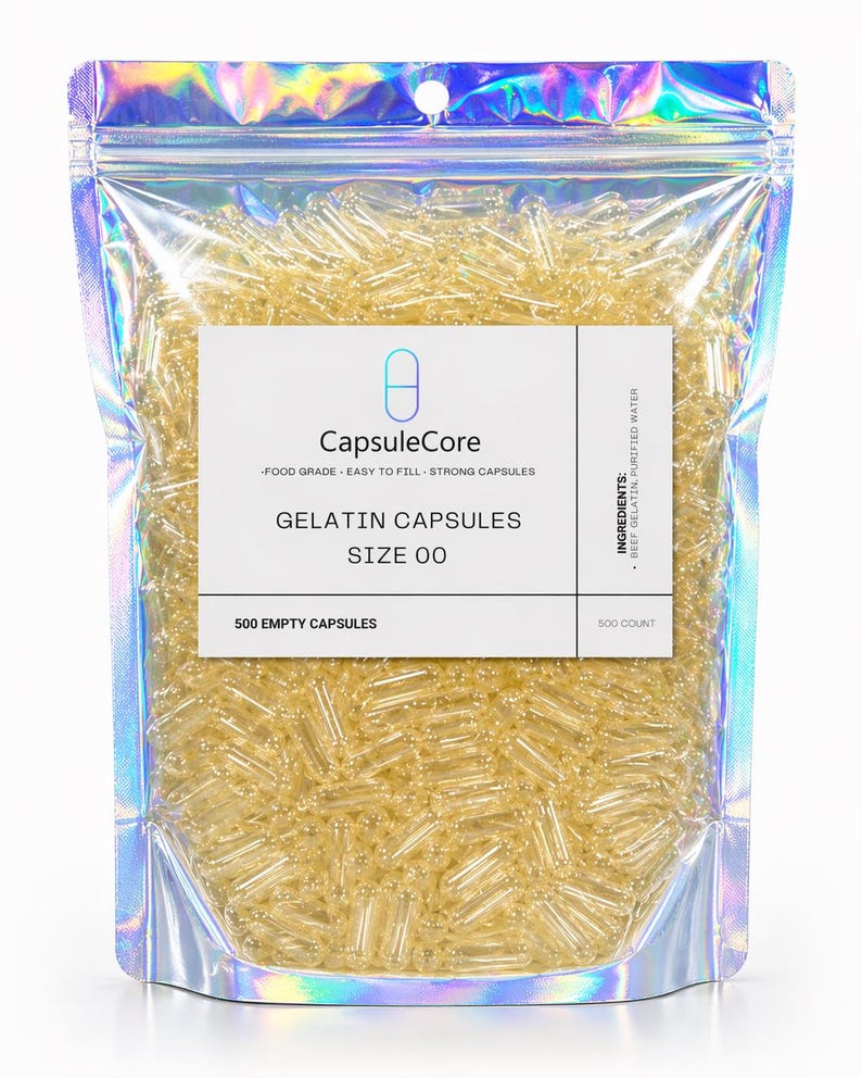 May include: A clear, holographic bag filled with numerous yellow gelatin capsules. The bag features a white label with the text "CapsuleCore," "Gelatin Capsules," and "Size 00." The label also indicates the contents are food grade and easy to fill. The bag contains 500 empty capsules.