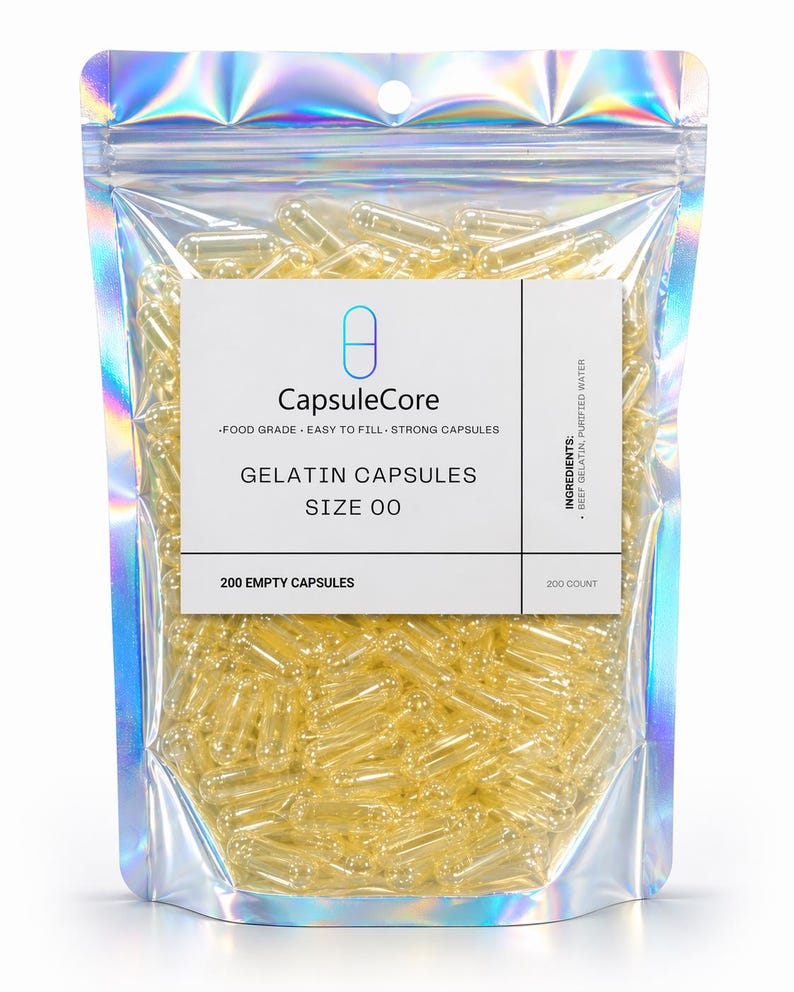 May include: A clear, resealable bag filled with numerous yellow gelatin capsules. The bag has a holographic, iridescent finish. A white label reads "CapsuleCore" and "Gelatin Capsules Size 00". The label also states "200 Empty Capsules".