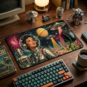 May include: A retro-themed mousepad featuring a space-themed illustration with a woman in a spacesuit, planets, UFOs, and a robot. A black mouse with colorful lights sits on the pad. A keyboard and other desk accessories are also visible.