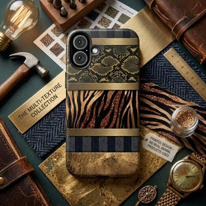 May include: A multi-texture phone case featuring a mix of animal print patterns, including snakeskin and zebra stripes, with gold-colored metal accents. The case has the text "THE MULTI-TEXTURE COLLECTION" and "PRINTED DESIGN - NO REAL ANIMAL PRODUCTS USED".
