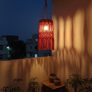 Handmade red macrame hanging lampshade with warm ambient light, boho cotton pendant lamp shade for cozy living room and bedroom decor