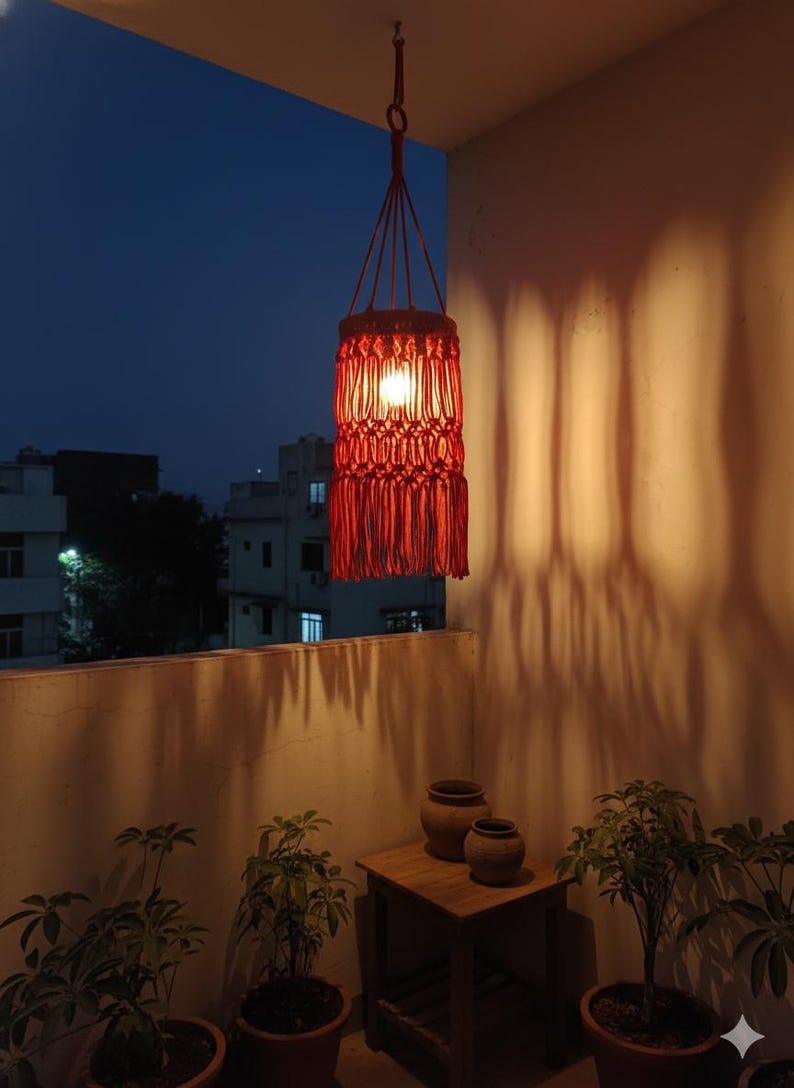 Handmade red macrame hanging lampshade with warm ambient light, boho cotton pendant lamp shade for cozy living room and bedroom decor