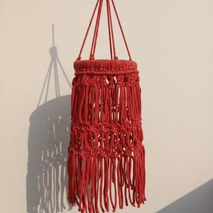 Handmade red macrame hanging lampshade with warm ambient light, boho cotton pendant lamp shade for cozy living room and bedroom decor