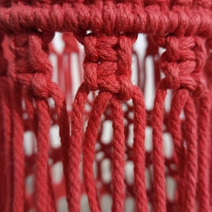 Handmade red macrame hanging lampshade with warm ambient light, boho cotton pendant lamp shade for cozy living room and bedroom decor