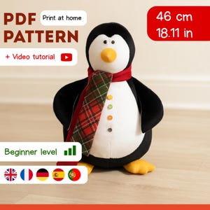 May include: A plush penguin with a red and green plaid scarf and colorful button accents. The penguin is approximately 18.11 inches tall and is a beginner level PDF pattern. The image includes the text "PDF PATTERN + Video tutorial".