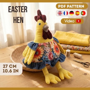 May include: A yellow Easter hen plush toy with a floral dress and denim trim. The hen has a red comb and wattle, and yellow feet. The text "EASTER HEN" is displayed. The hen measures 10.6 inches.