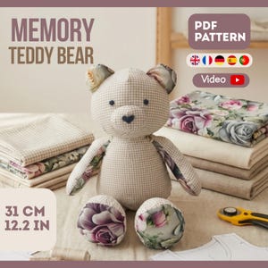 May include: A handmade teddy bear, approximately 12.2 inches (31 cm) tall, made from beige gingham fabric with floral accents. The bear has a heart-shaped nose and is surrounded by fabric and sewing supplies. The image includes the text "MEMORY TEDDY BEAR" and "PDF PATTERN".