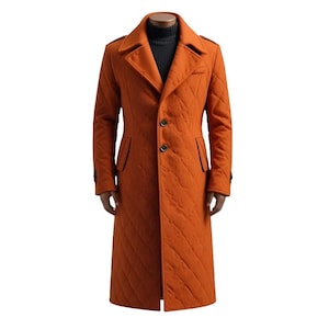 May include: An orange quilted coat with a classic design. The long coat features a notched collar, button closure, and black trim. The coat is displayed on a mannequin and is a stylish outerwear option.