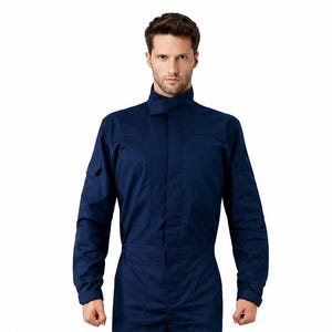 May include: A navy blue long-sleeve jumpsuit featuring a high collar with a tab closure, a front zipper concealed by a placket, two chest pockets, two thigh pockets with flaps, and long sleeves with cuffs, worn with black leather dress shoes.
