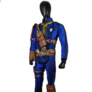 May include: A blue jumpsuit with yellow accents, brown leather pouches, and a matching belt. The costume features knee and shoulder pads, and black gloves. The outfit is displayed on a mannequin.