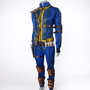 May include: A blue and yellow jumpsuit with brown leather accents, including a shoulder strap, belt, and knee pads. The costume features a high collar, a front zipper, and several small vials attached to the belt. The outfit is designed with a futuristic aesthetic.