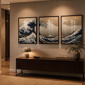 Può includere: Interno con tre stampe incorniciate raffiguranti un motivo a onde giapponesi in blu e bianco. Sotto le opere d'arte si trova una consolle in legno scuro con una lampada e decorazioni. Sono visibili anche uno specchio rotondo e un corridoio.