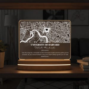 May include: A lighted map of the University of Harvard, with the name "Volet Hankook" and the years "2010-2014" printed below the map. The map is set on a wooden base with a glowing light.