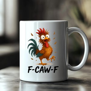 May include: White ceramic mug featuring a cartoon rooster with a red comb, orange feathers, and a green tail. The rooster has a surprised expression with its tongue out. The text "F-CAW-F" is printed below the rooster.