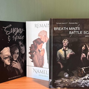 May include: Three hardcover books with illustrated covers. The first book is black with the title "Sugar & Spice" and a drawing of three people. The second book is white with the title "Remain" and a couple. The third book is dark with the title "Breath Mints Battle Scars".