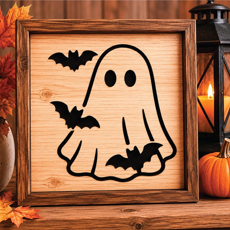 May include: Wooden Halloween sign featuring a black ghost and bats design. The artwork is set within a brown wooden frame. The background has a wood grain texture. The sign is a decorative item for the Halloween season.