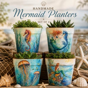 May include: A set of four cylindrical ceramic planters featuring watercolor-style illustrations of mermaids and sea life. The pots display a seahorse, a mermaid with a seahorse, jellyfish, and a mermaid sitting on a rock. Text reads HANDMADE Mermaid Planters SET OF 4.