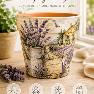 May include: A terracotta clay pot featuring a decoupage design of a lavender field, a stone house, and a metal pitcher. The text Lavande de Provence is printed on the front. The pot has a wide rim and a natural orange interior finish.