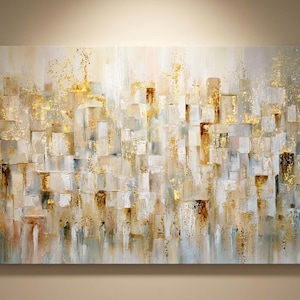May include: Abstract cityscape painting with a textured, layered effect. The artwork features a palette of neutral tones, including beige, white, and gold, creating a sense of depth and dimension. The rectangular shapes evoke a city skyline.