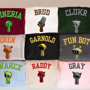 May include: A set of three ceramic mugs with a speckled, matte finish. The mugs are in shades of cream, light brown, and dark brown. Each mug has a simple, minimalist design, perfect for coffee or tea.