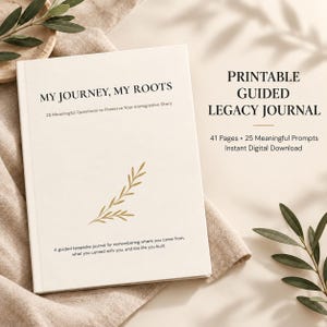Peut inclure: Un journal blanc intitulé My Journey, My Roots avec le sous-titre 25 Meaningful Questions to Preserve Your Immigration Story. La couverture présente une illustration de feuille dorée et un texte le décrivant comme un journal souvenir guidé.