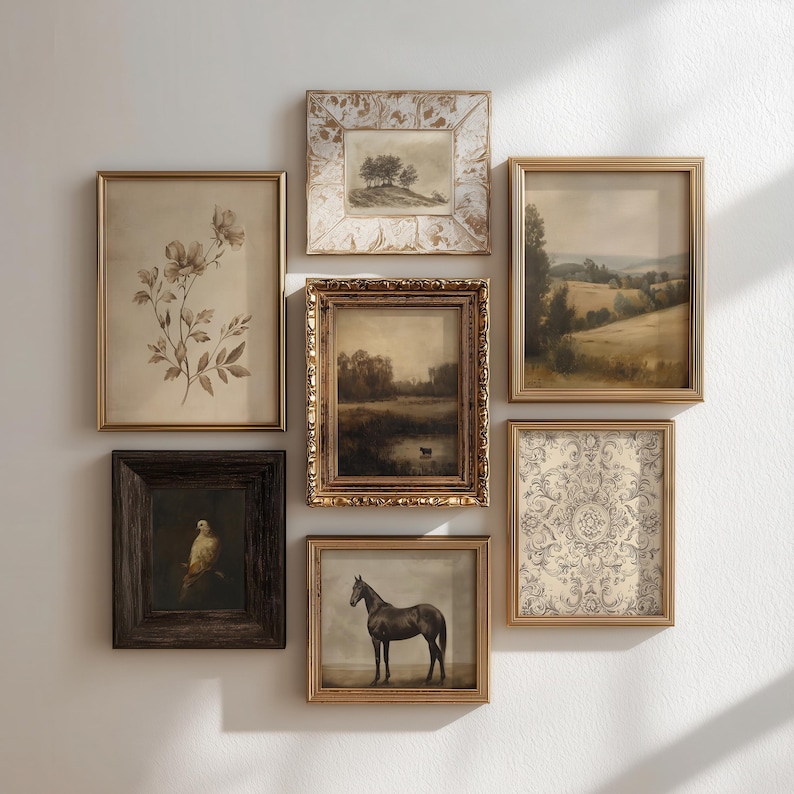 May include: A gallery wall arrangement featuring seven framed artworks. The collection includes botanical sketches, landscape paintings, a bird portrait, a horse study, and an ornate damask pattern, all housed in varied gold, white, and dark wood frames.