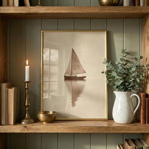 May include: A framed print of a sailboat on calm water, with a gold frame. The print is displayed on a wooden shelf with a brass candlestick, a small brass bowl, a white pitcher with greenery, and books. The background is a muted green.