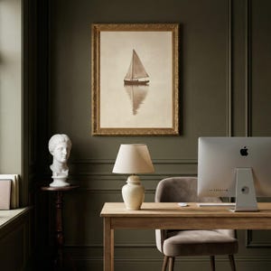May include: A sepia-toned framed print of a sailboat on calm water hangs above a wooden desk. A white lamp with a beige shade sits on the desk, next to a computer. A white bust and a wooden side table are also in the room.