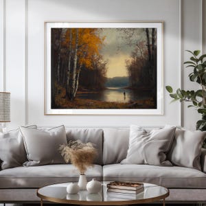May include: A framed landscape painting depicting a calm lake surrounded by a dense forest with autumn foliage in shades of yellow and orange. A small, solitary figure stands near the water's edge under a soft, overcast sky with muted light.