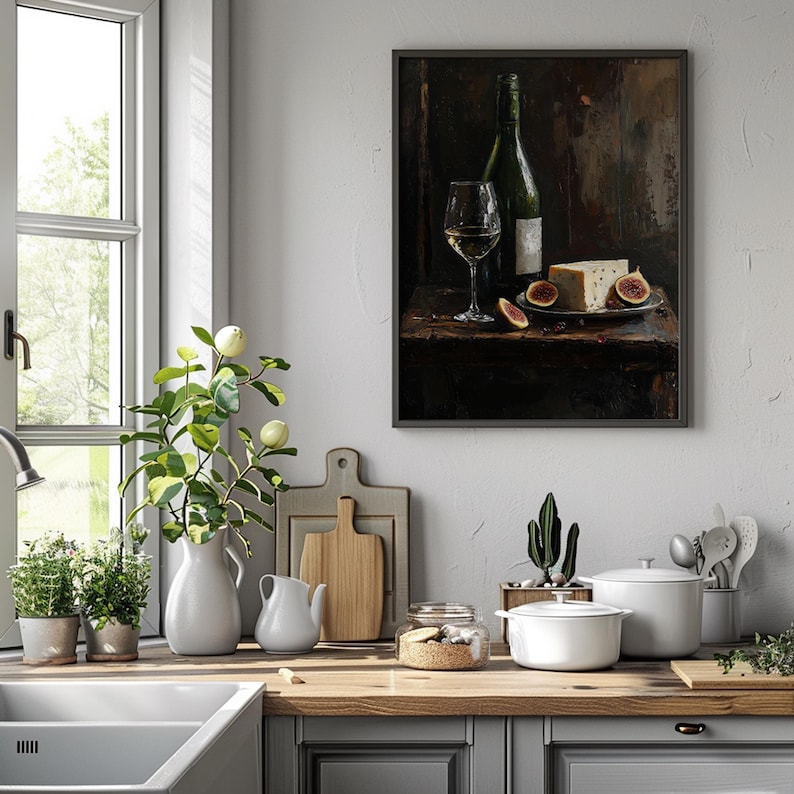 May include: A framed wall art print depicting a dark, moody still life scene featuring a green wine bottle, a clear glass of white wine, a wedge of cheese, and sliced figs arranged on a rustic wooden surface with a deep brown background.