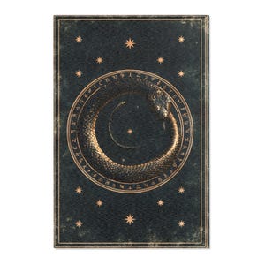 May include: A rectangular dark charcoal wall art print featuring a gold Ouroboros snake eating its own tail inside a circular border of runic symbols. The design is accented with small gold stars scattered across the textured dark background.
