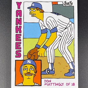 May include: A baseball card featuring a cartoon illustration of Don Mattingly of the Yankees. The card has a white background with the word "Yankees" in pink. The illustration shows Mattingly in a baseball uniform, with a close-up portrait of him in the lower left corner.