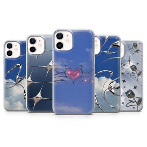 May include: Five smartphone cases featuring Y2K-inspired designs. The cases display blue sky backgrounds with white clouds, metallic silver chrome-like abstract shapes, a central pink heart, and silver tulip illustrations with four-pointed stars.