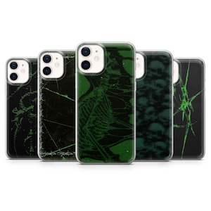May include: A collection of five phone cases with unique designs. The cases feature dark backgrounds with green graphics, including a skeleton, barbed wire, and abstract patterns. The cases are designed to fit various phone models.