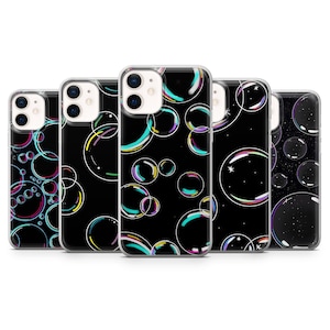 May include: A collection of five phone cases with a black background and colorful bubble designs. The bubbles vary in size and have iridescent rainbow-colored edges. The cases are designed for a smartphone.