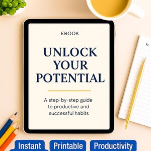 May include: An ebook titled "UNLOCK YOUR POTENTIAL" displayed on a tablet, with the text "A step-by-step guide to productive and successful habits." A cup of coffee, pencils, and a notepad with a gold pen are also present.