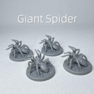 May include: Four gray miniature giant spider figurines. Each spider is on a circular base. The text "Giant Spider" is displayed in white above the figurines. The spiders have multiple legs and a detailed body.