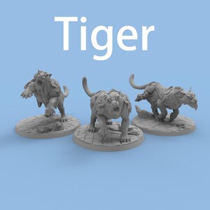 May include: Three grey tiger figurines on round bases, each in a different pose. The tigers have detailed fur and decorative elements. The word "Tiger" is written in large white letters above the figurines against a light blue background.