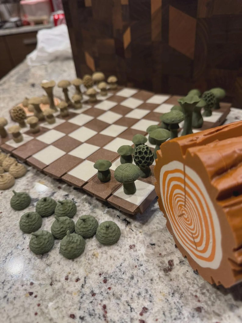 May include: A unique chess set with mushroom-shaped pieces in shades of green and tan. The board features a brown and cream checkered pattern. A decorative log slice is on the side, adding to the forest theme.