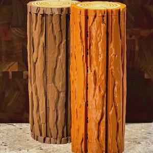 May include: Two decorative log-shaped containers. One is a light brown color, and the other is orange. Both have a textured bark design and a cross-section top with concentric circles, resembling a tree trunk. The containers are cylindrical and stand upright.