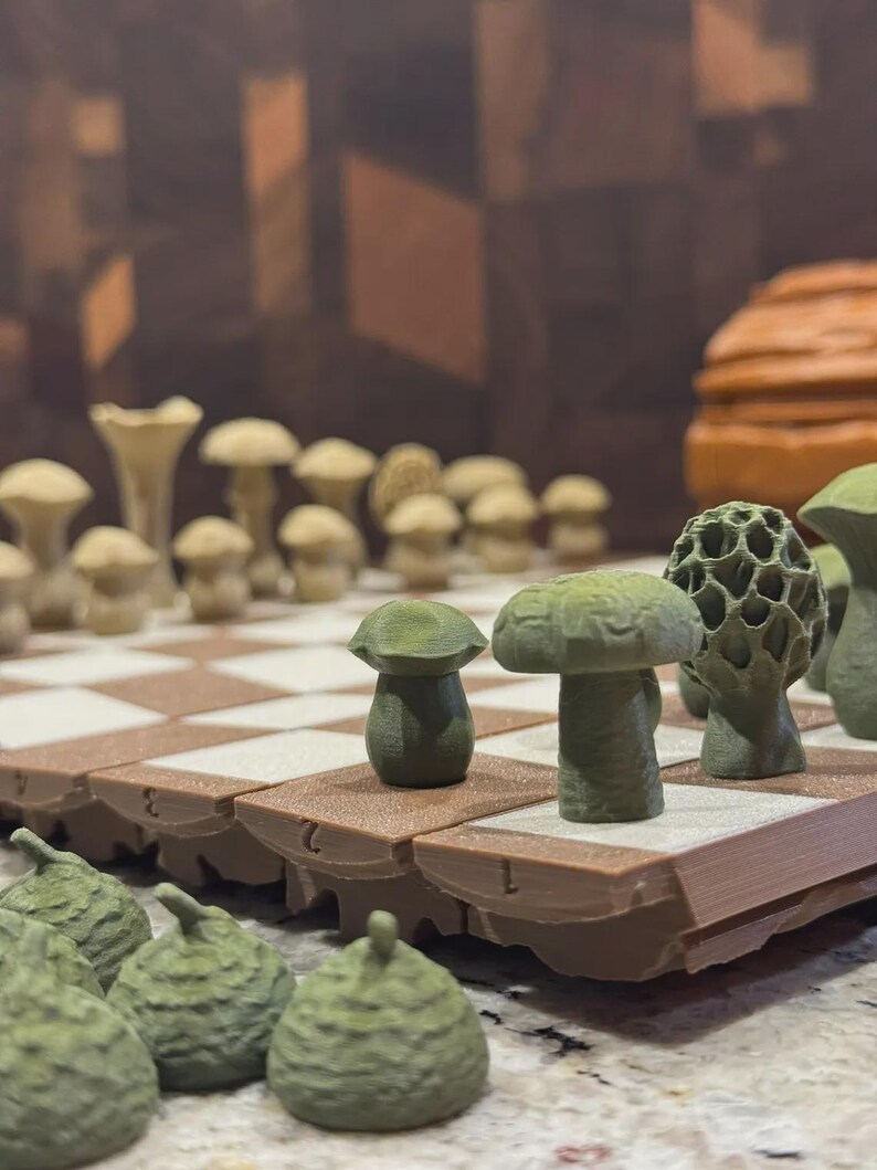 May include: A unique chess set featuring mushroom-shaped pieces in shades of green and tan. The board has a brown and white checkered pattern. The pieces are arranged on the board, ready for play. The set is a creative take on a classic game.