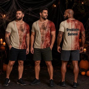 May include: A short-sleeve t-shirt featuring a printed graphic of a bare chest with hair and a blood-splattered design. The back of the shirt displays the text "Problem Solved" in a dripping font style, set against a beige and red colour scheme.