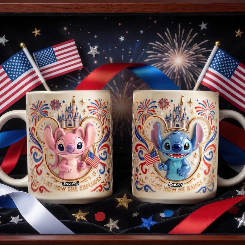 May include: Two cream-colored ceramic mugs featuring embossed 3D characters. The left mug shows a pink creature with the text 'Isabelle' and 'I LIKE HOW SHE EXPLODES'. The right mug shows a blue creature with 'Johnny' and 'I LIKE HOW HE BANGS'.