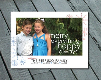 May include: A Christmas card featuring a photo of two children, a boy and a girl, standing in front of a green bush. The card has a white background with red and blue snowflakes and the text "merry everything happy always" and "with love... THE PETRUSO FAMILY ANTHONY JACKIE ALEXA JARED".