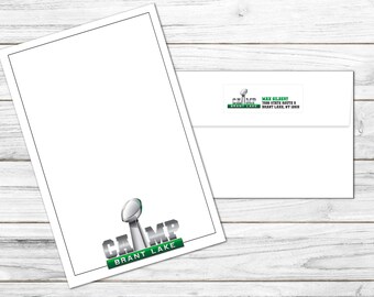 May include: A white card with a black border and a green and silver logo that says "CAMP BRANT LAKE". The logo features a silver football trophy. A white envelope with a green and silver label that says "CAMP BRANT LAKE" and "MAX GILBERT 1008 STATE ROUTE 8 BRANT LAKE, NY 12815" is in the background.