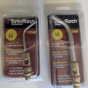 May include: Two TurboTorch Professional acetylene tips, A-2 and A-8, in their original packaging. The packaging is clear plastic with a red and black label. The tips are made of metal and have a curved design.