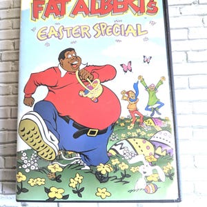 May include: A DVD case for Fat Albert's Easter Special. The cover shows Fat Albert in a red top and blue trousers, holding a basket. Other characters are in a field with Easter eggs and butterflies. The title is in large, colourful letters.