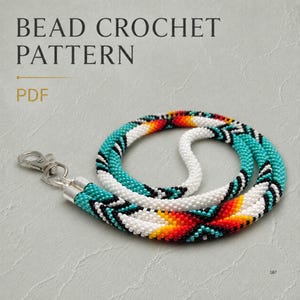 May include: A beaded lanyard featuring a geometric pattern in white, turquoise, black, yellow, and red. The lanyard is constructed from small seed beads and includes a silver-toned metal lobster clasp. Text reads: BEAD CROCHET PATTERN PDF.