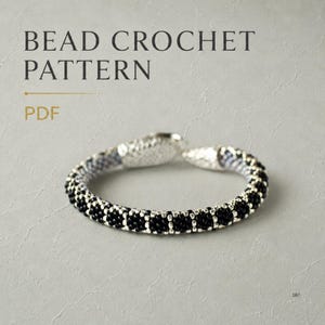 May include: A bead crochet pattern PDF featuring a circular bracelet made of small black beads with silver-toned metallic end caps. The text BEAD CROCHET PATTERN PDF is displayed in the upper portion of the image against a light grey background.